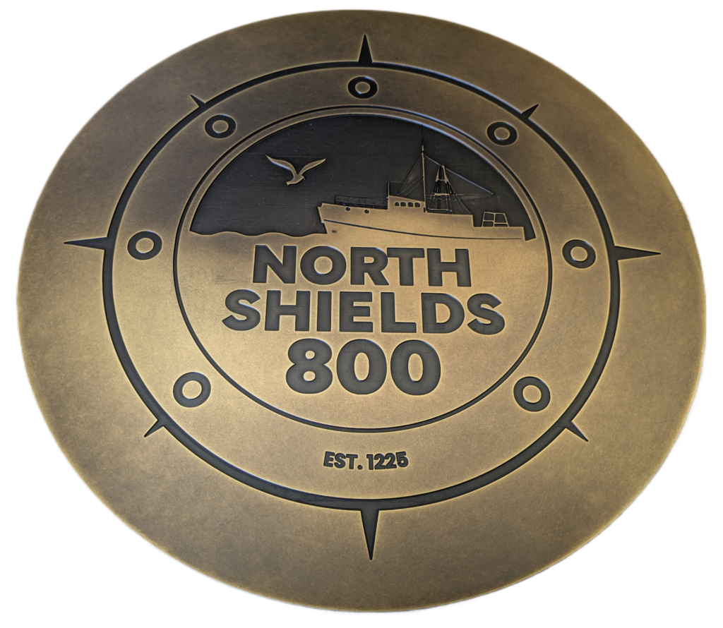 Close-up of engraved brass lettering prepared for finishing