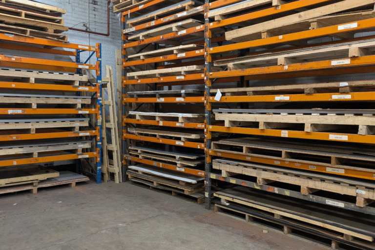 Sheet metal stock stored on pallet racking at MS Laser Services, ready for laser cutting